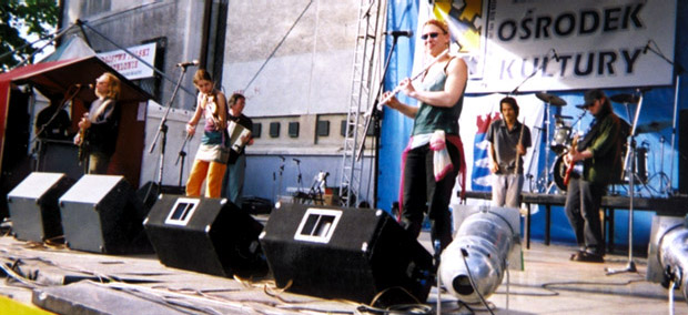 full band on stage in the sun in Poland