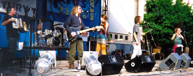 full band on stage in the sun in Poland